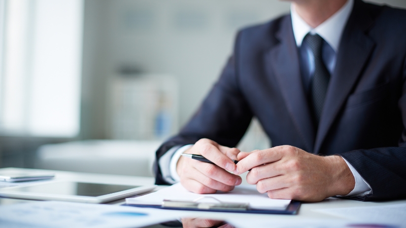 Business leader at a desk reviewing documents, symbolizing COO vs CEO differences in company leadership roles