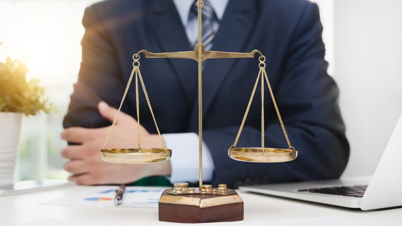 A businessman with scales on his desk represents balance and strategy in scaling up in business