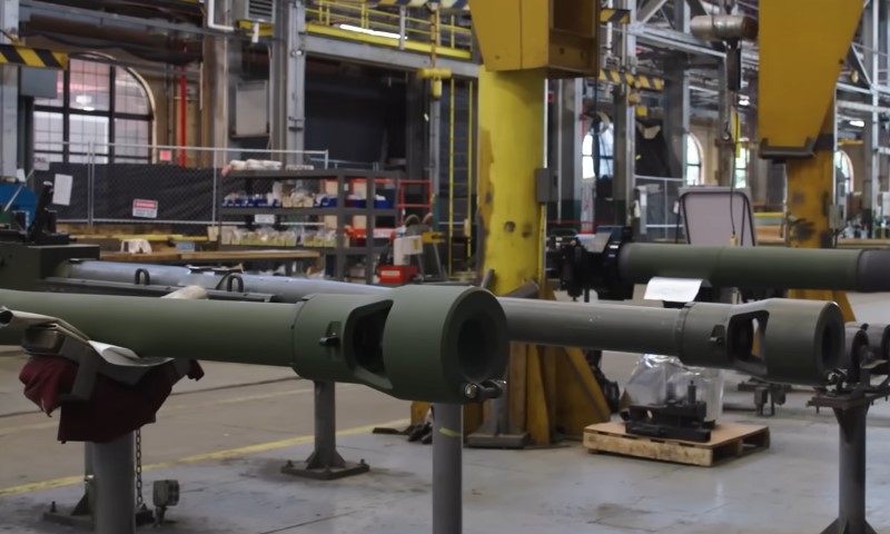 A factory scene featuring large pipes and various machinery, illustrating an industrial environment