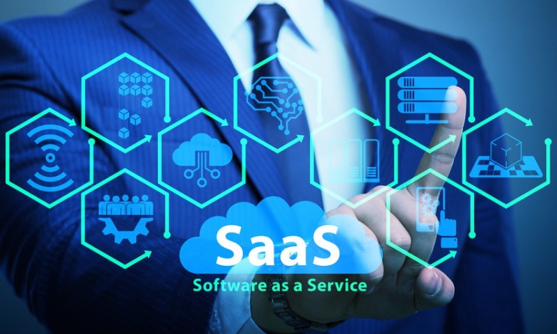 A person in a suit touches holographic icons representing SaaS concepts like cloud computing, data storage, and teamwork